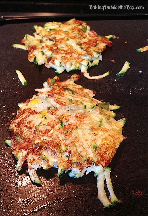 Fry the zucchini patties on a lightly greased griddle or frying pan till golden brown and hot.