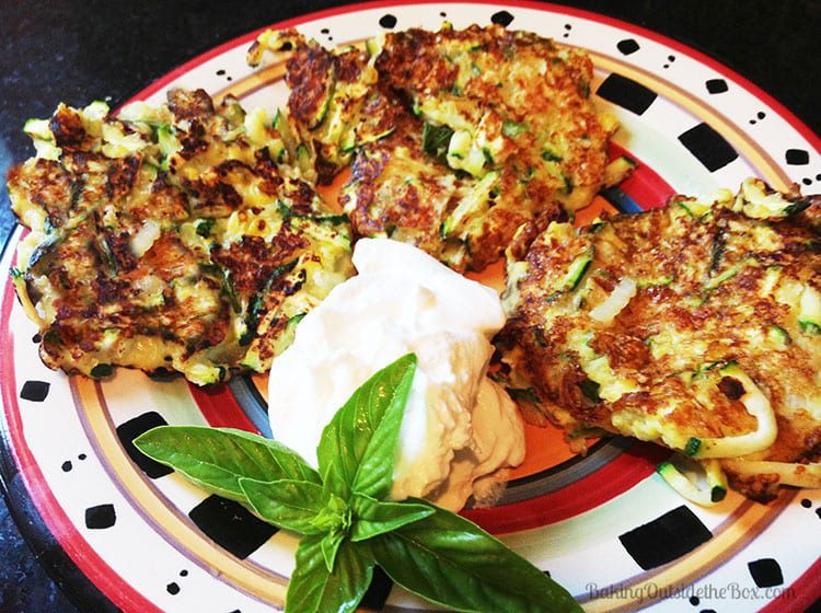 Low Carb keto Zucchini Patties have an extra zing when you use fresh basil, Parmesan and add a dash of sriracha sauce. Hot and on the table in 20 minutes. #bakingoutsidethebox #zucchinipatties
